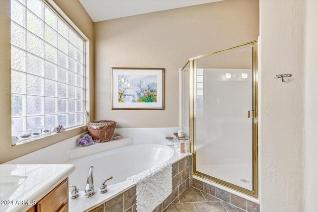 bathroom with vanity, shower with separate bathtub, and tile patterned flooring