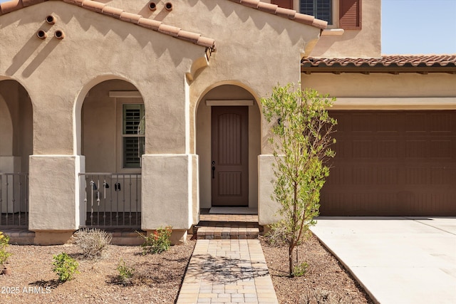 20473 W Legend Trl, Buckeye, AZ 85396 - view of exterior entry featuring stucco siding, concrete driveway, and a tile roof