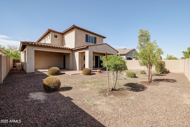20473 W Legend Trl, Buckeye, AZ 85396 - back of property with stucco siding, a fenced backyard, a tile roof, and a garage