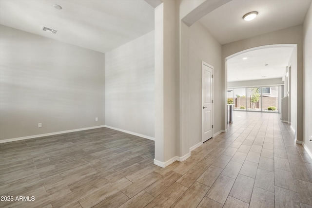 20473 W Legend Trl, Buckeye, AZ 85396 - corridor featuring arched walkways, wood finished floors, and baseboards