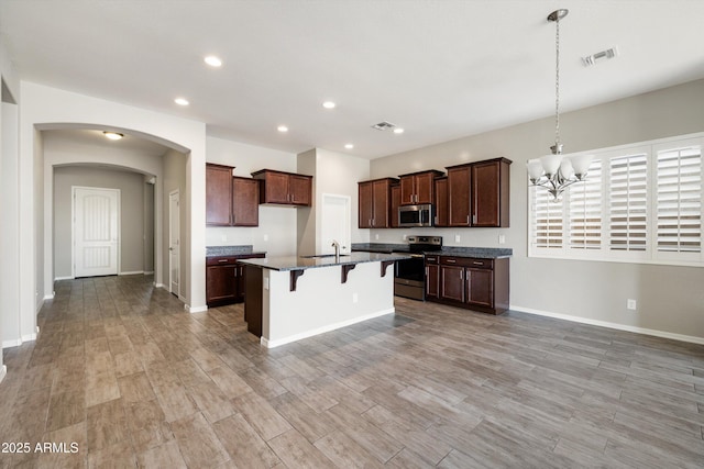 20473 W Legend Trl, Buckeye, AZ 85396 - kitchen with stainless steel appliances, a sink, recessed lighting, a chandelier, and a kitchen island with sink