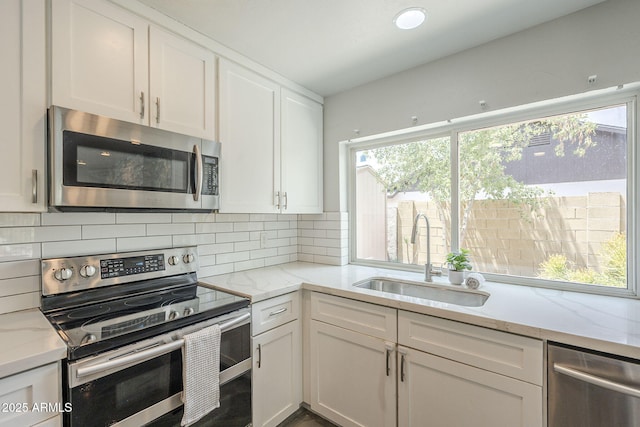 5330 E Tierra Buena Ln, Scottsdale, AZ 85254 - kitchen featuring stainless steel appliances, a sink, white cabinetry, and plenty of natural light