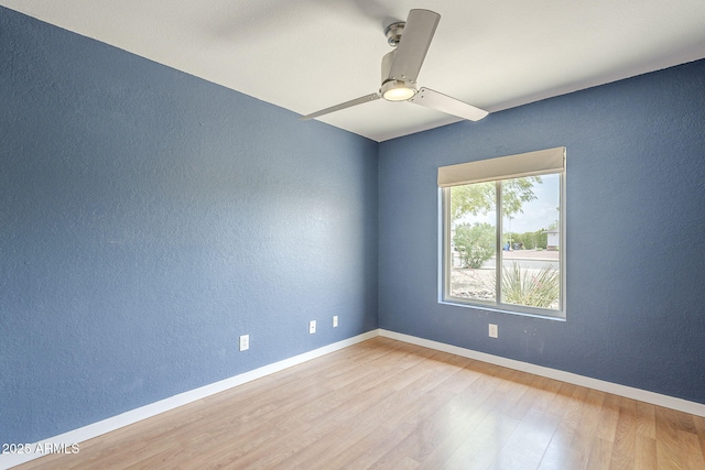 5330 E Tierra Buena Ln, Scottsdale, AZ 85254 - unfurnished room with a textured wall, wood finished floors, ceiling fan, and baseboards