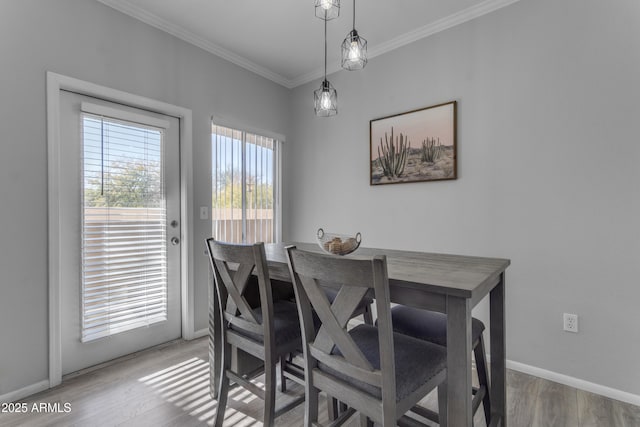 dining space featuring crown molding and wood-type flooring