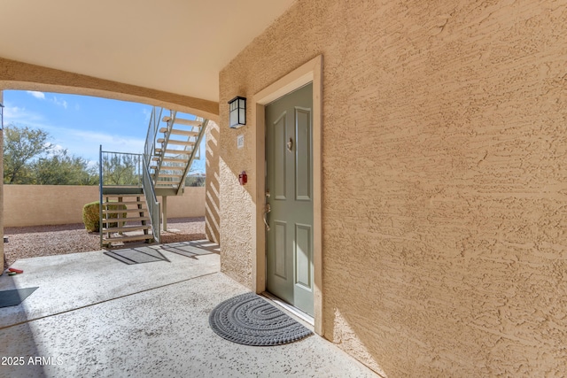 view of exterior entry with a patio area