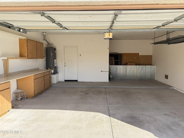 garage with a garage door opener and gas water heater