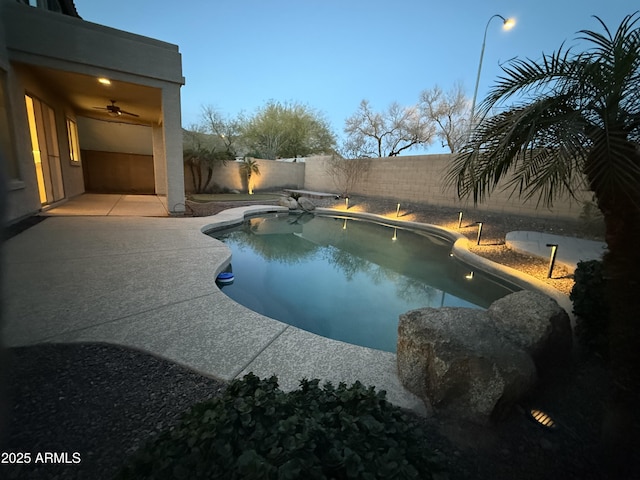 view of swimming pool with a fenced in pool, a fenced backyard, and a patio
