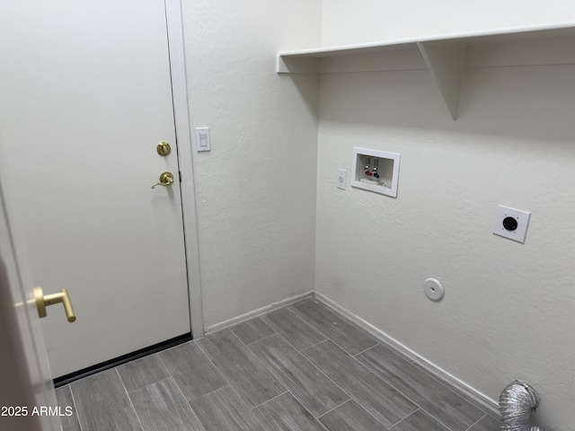 clothes washing area featuring laundry area, baseboards, hookup for a washing machine, wood tiled floor, and electric dryer hookup