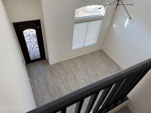 foyer entrance with light wood-type flooring and stairs