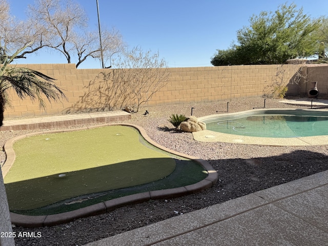 view of pool with a fenced backyard