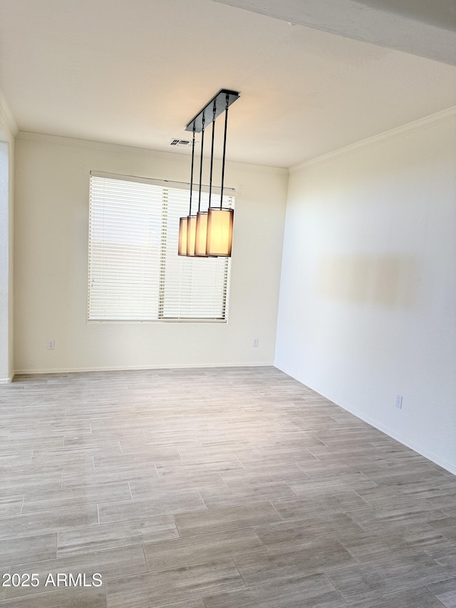 empty room with ornamental molding and wood finish floors