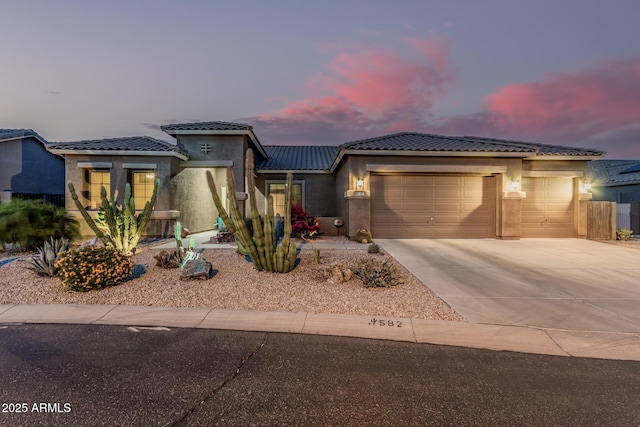 582 W Stirrup Ln, San Tan Valley, AZ 85143 - prairie-style house featuring stucco siding, a garage, a tiled roof, and concrete driveway