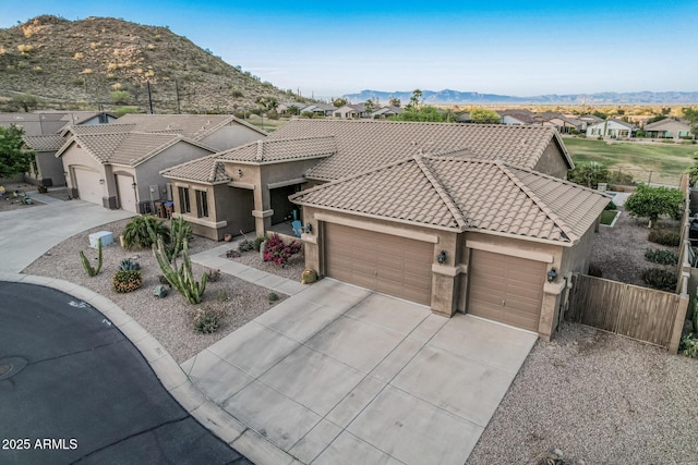 582 W Stirrup Ln, San Tan Valley, AZ 85143 - view of front of property with fence, a tiled roof, stucco siding, driveway, and a garage