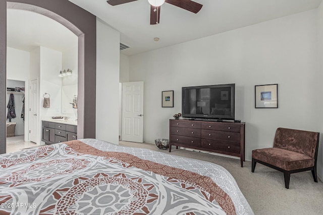 582 W Stirrup Ln, San Tan Valley, AZ 85143 - bedroom featuring a spacious closet, ceiling fan, light carpet, ensuite bath, and visible vents