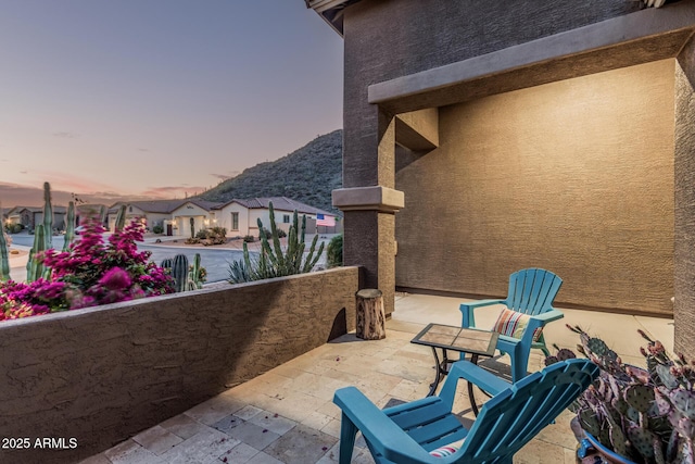 582 W Stirrup Ln, San Tan Valley, AZ 85143 - patio terrace at dusk with a balcony and a mountain view