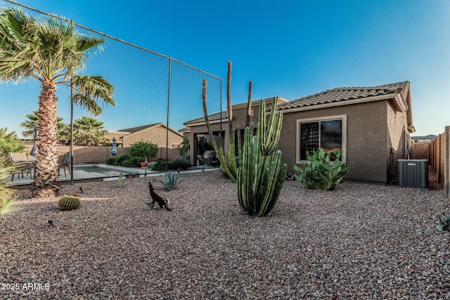 582 W Stirrup Ln, San Tan Valley, AZ 85143 - view of front facade with central air condition unit, stucco siding, a tile roof, a patio area, and fence private yard