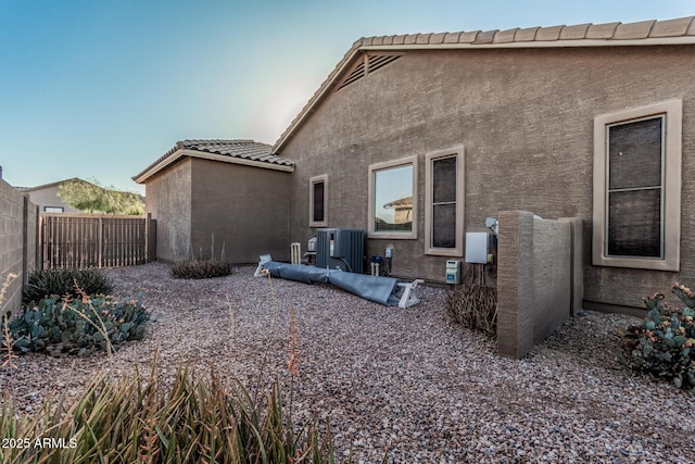 582 W Stirrup Ln, San Tan Valley, AZ 85143 - back of house featuring stucco siding, fence, central AC, and a tiled roof