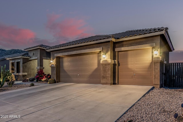 582 W Stirrup Ln, San Tan Valley, AZ 85143 - prairie-style house featuring an attached garage, a tiled roof, stucco siding, and concrete driveway