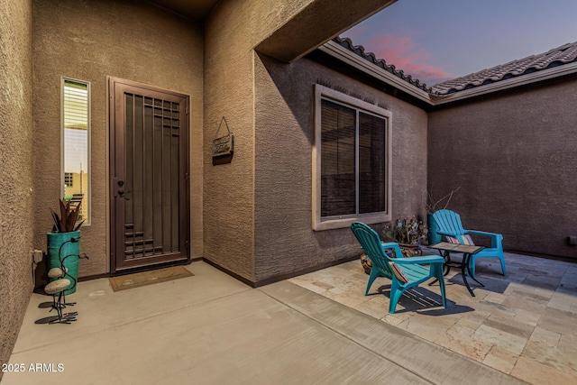 582 W Stirrup Ln, San Tan Valley, AZ 85143 - doorway to property featuring a tile roof, a patio, and stucco siding