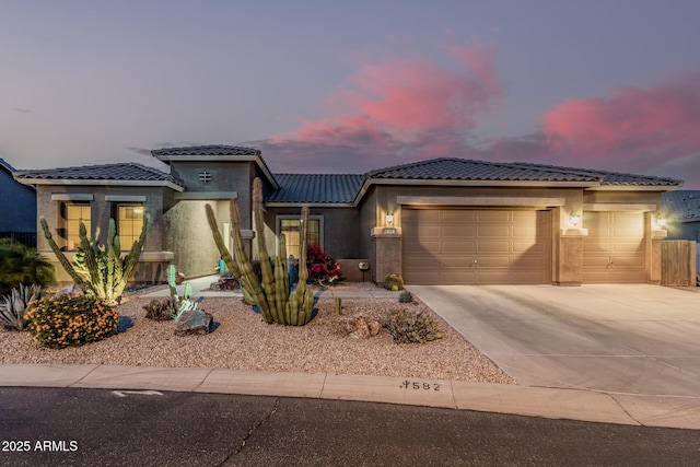 582 W Stirrup Ln, San Tan Valley, AZ 85143 - prairie-style house with stucco siding, a tile roof, concrete driveway, and a garage