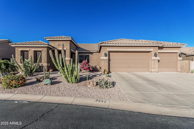 582 W Stirrup Ln, San Tan Valley, AZ 85143 - mediterranean / spanish-style house featuring stucco siding, an attached garage, driveway, and a tile roof