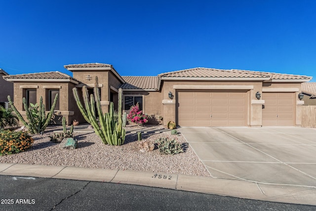 582 W Stirrup Ln, San Tan Valley, AZ 85143 - view of front of property featuring stucco siding, an attached garage, a tile roof, and driveway