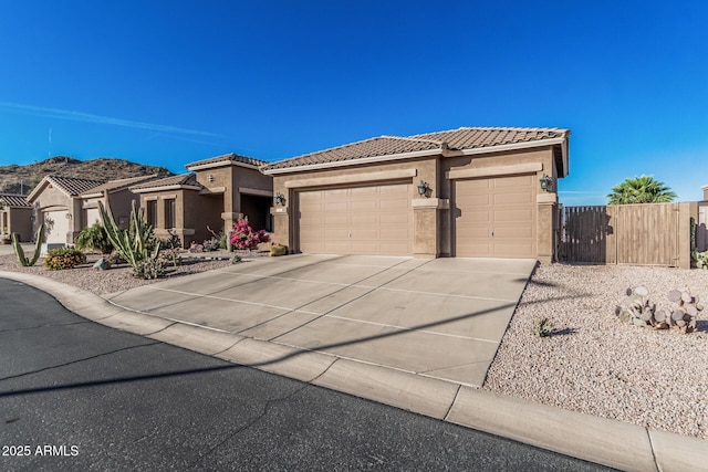582 W Stirrup Ln, San Tan Valley, AZ 85143 - view of front of property with fence, stucco siding, an attached garage, a tile roof, and driveway