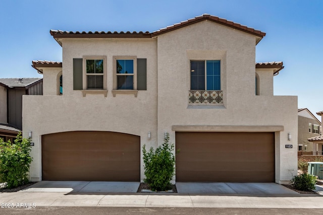 1153 W Diamondback Dr, Chandler, AZ 85286 - mediterranean / spanish home featuring an attached garage, a tiled roof, and stucco siding