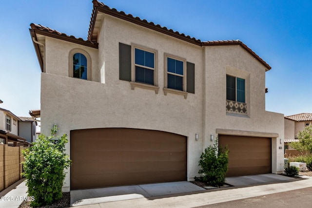 1153 W Diamondback Dr, Chandler, AZ 85286 - mediterranean / spanish house featuring an attached garage, stucco siding, and a tiled roof