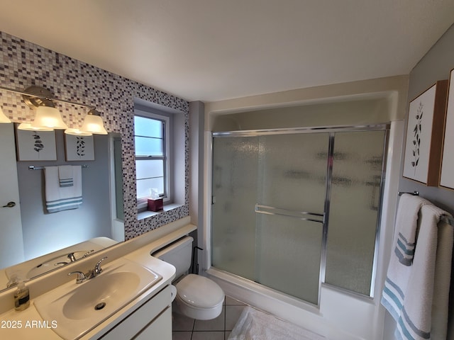 bathroom featuring tile patterned flooring, vanity, an enclosed shower, and toilet