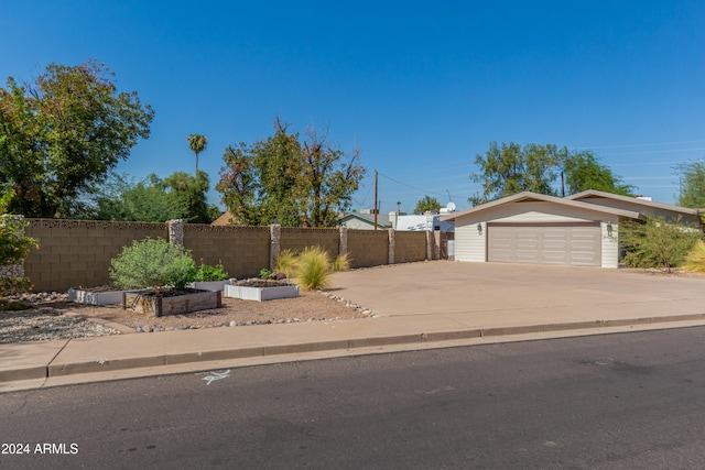 view of front of house with a garage and an outdoor structure