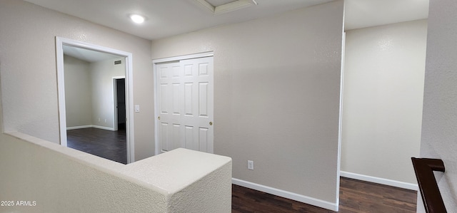 hallway with dark hardwood / wood-style floors