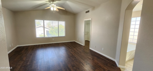 unfurnished room with ceiling fan, dark hardwood / wood-style floors, a wealth of natural light, and lofted ceiling