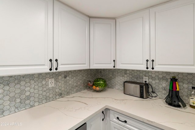 kitchen featuring white cabinets and backsplash