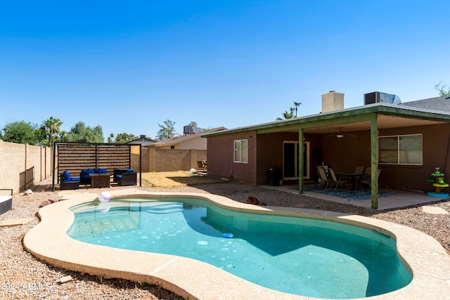 view of pool featuring a patio, central AC, and outdoor lounge area