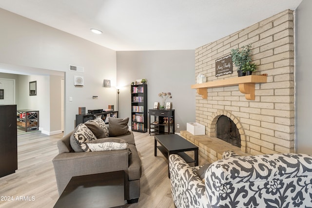 living room featuring light wood-type flooring and a fireplace