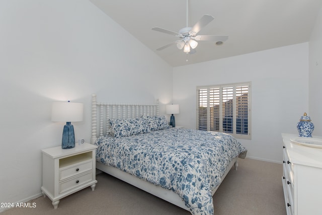 bedroom with ceiling fan, vaulted ceiling, and light colored carpet