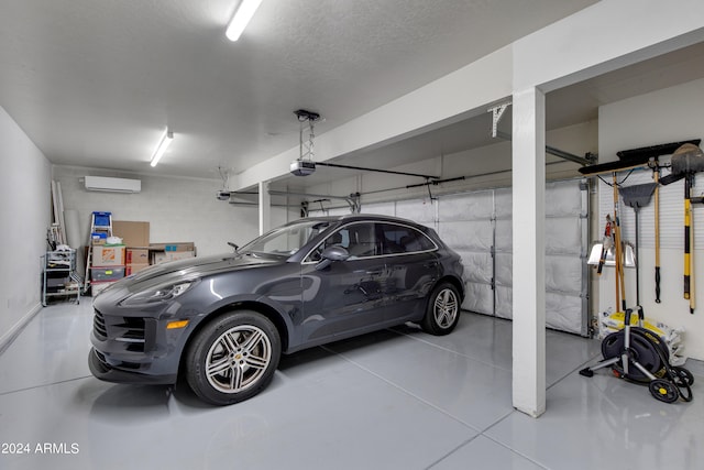 garage with a garage door opener and a wall mounted AC