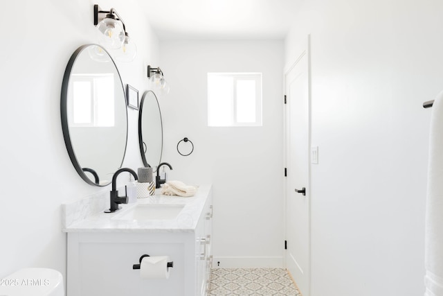 bathroom with vanity, plenty of natural light, and toilet