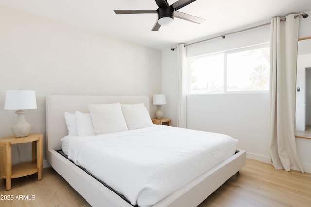 bedroom with ceiling fan and light wood-type flooring