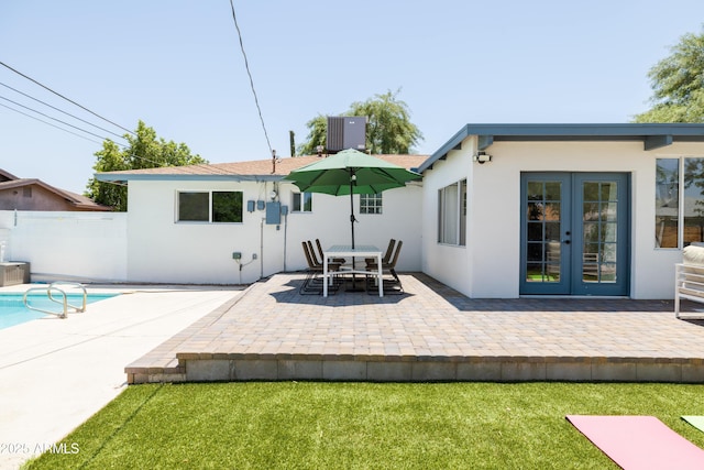 back of house with a patio, a yard, central AC unit, and french doors