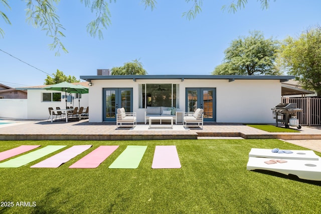 back of property featuring french doors, a yard, outdoor lounge area, and a patio