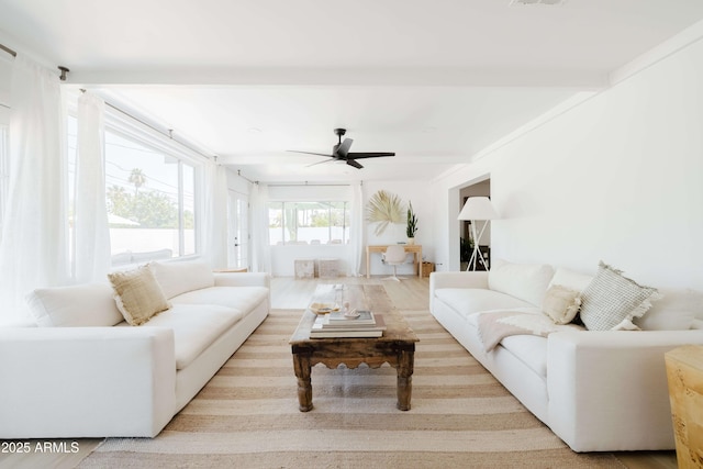 living room with beam ceiling, light hardwood / wood-style flooring, and ceiling fan