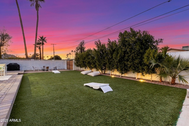 yard at dusk with a patio