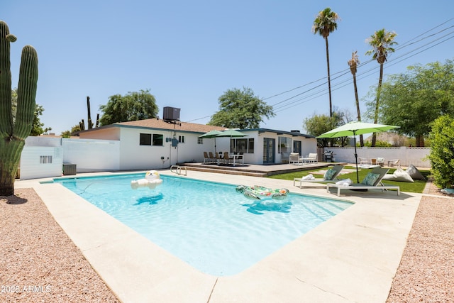 view of swimming pool featuring a patio and central air condition unit