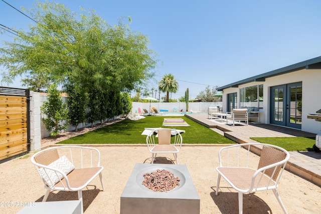 view of patio / terrace featuring a pool, french doors, and an outdoor fire pit