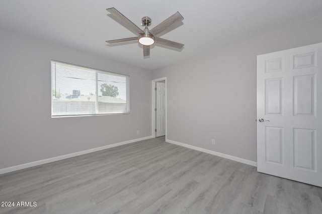 spare room featuring ceiling fan and light hardwood / wood-style floors