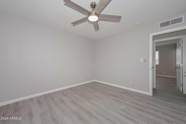 spare room with ceiling fan and light wood-type flooring