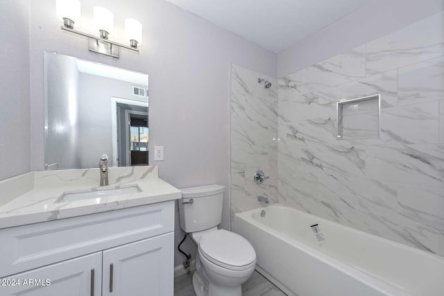 full bathroom featuring vanity, toilet, and tiled shower / bath