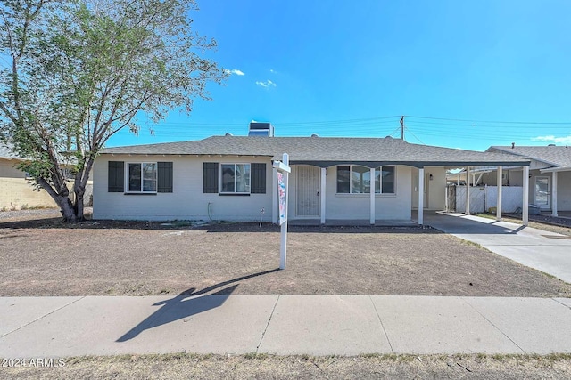 ranch-style home with a carport